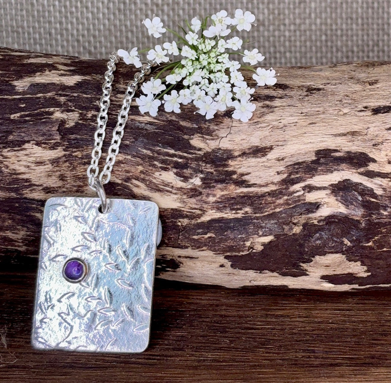 Pendant with birds and amethyst gemstone