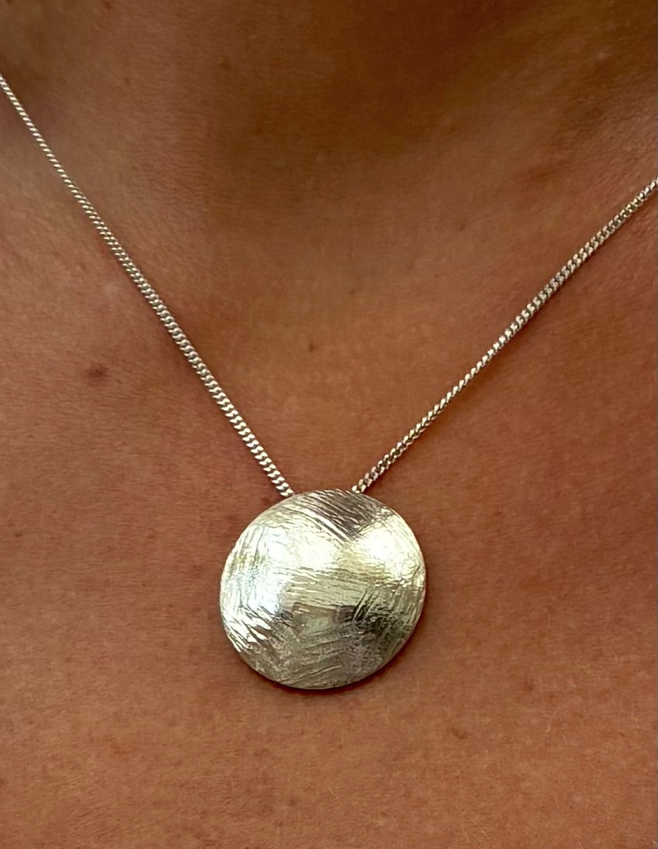 Domed textured silver disc pendant