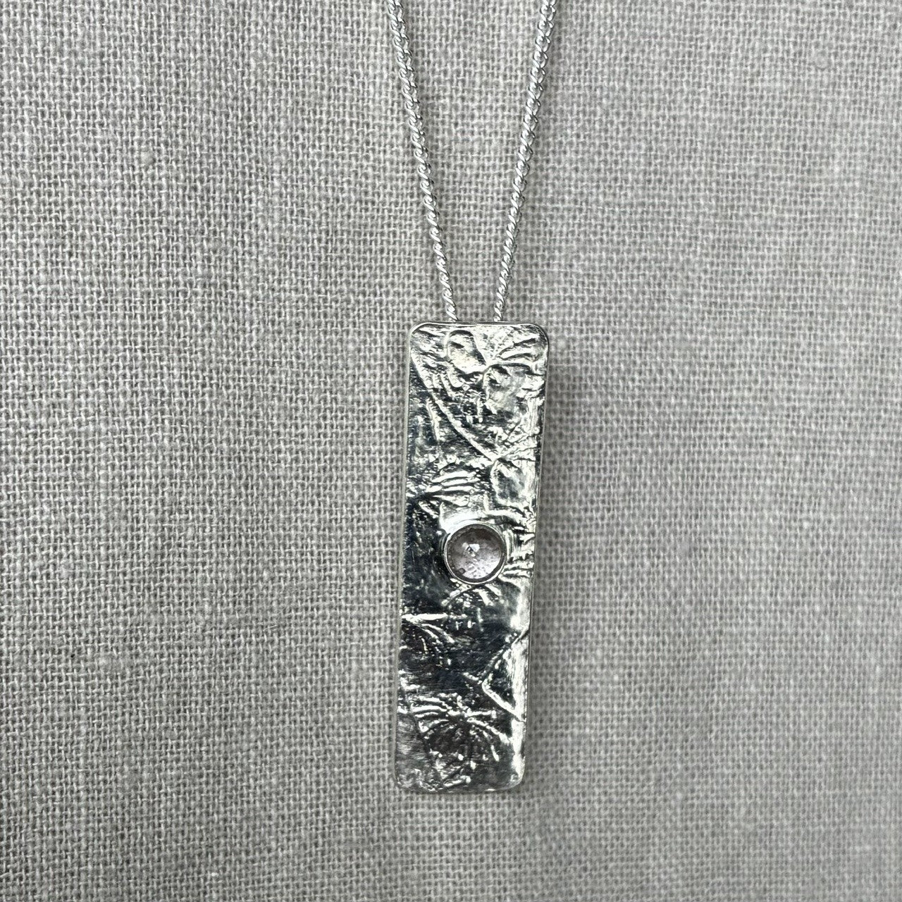Drop pendant featuring an iodite gemstone.