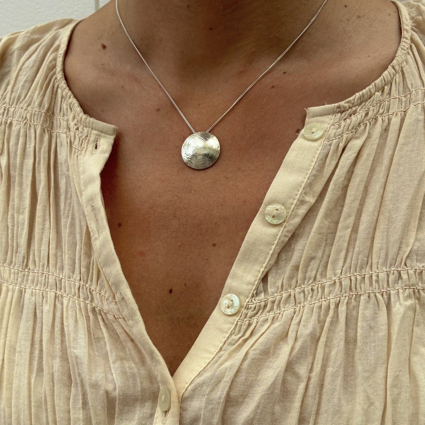 Domed textured silver disc pendant