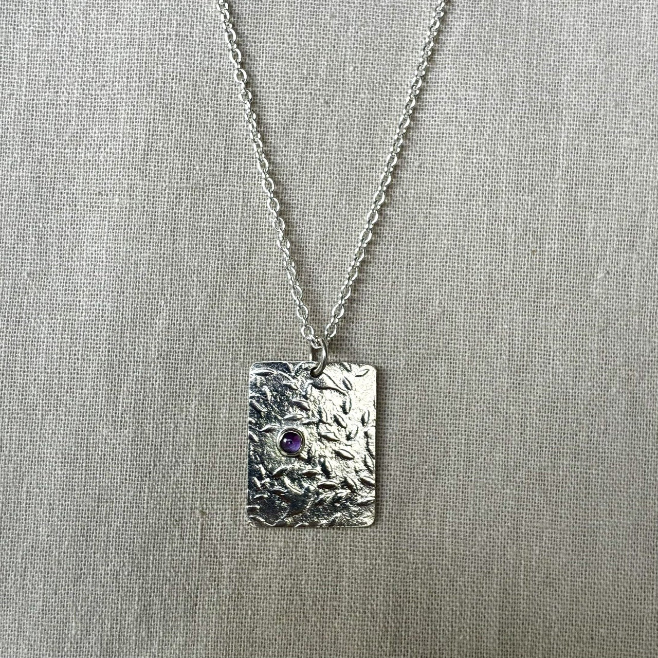 Pendant with birds and amethyst gemstone