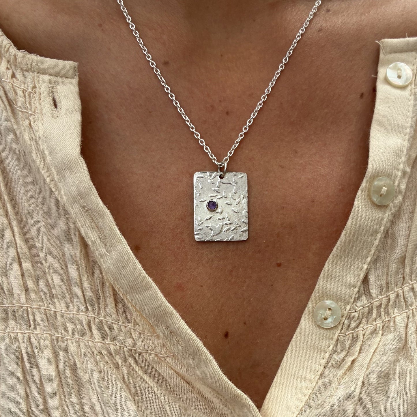 Pendant with birds and amethyst gemstone