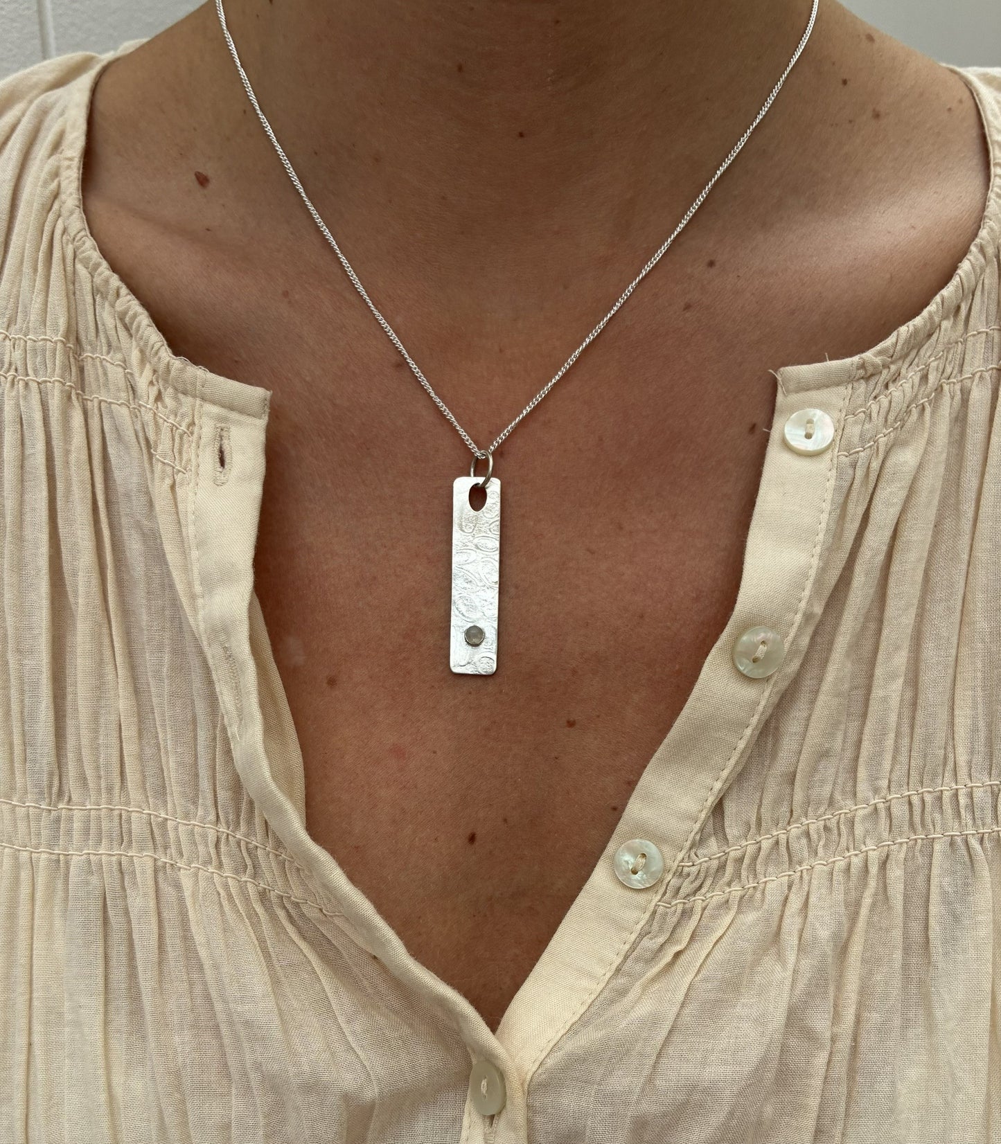 Pendant with rippled stone texture and labradorite gemstone